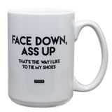 White 15oz. ceramic drinking mug with the saying, "Face down ass up thats the way i like to tie my shoes."